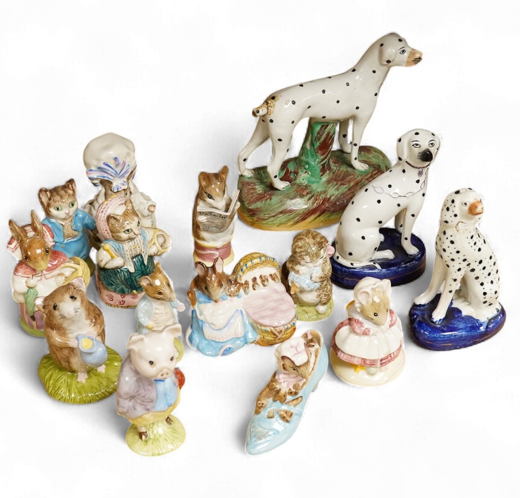 A collection of Beatrix Potter figures, three Staffordshire Dalmatians and a Copenhagen Dalmatian, tallest 16cm high